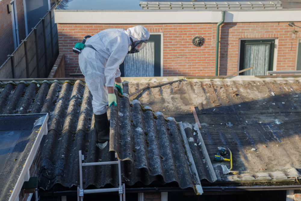 Man removing asbestos on roof