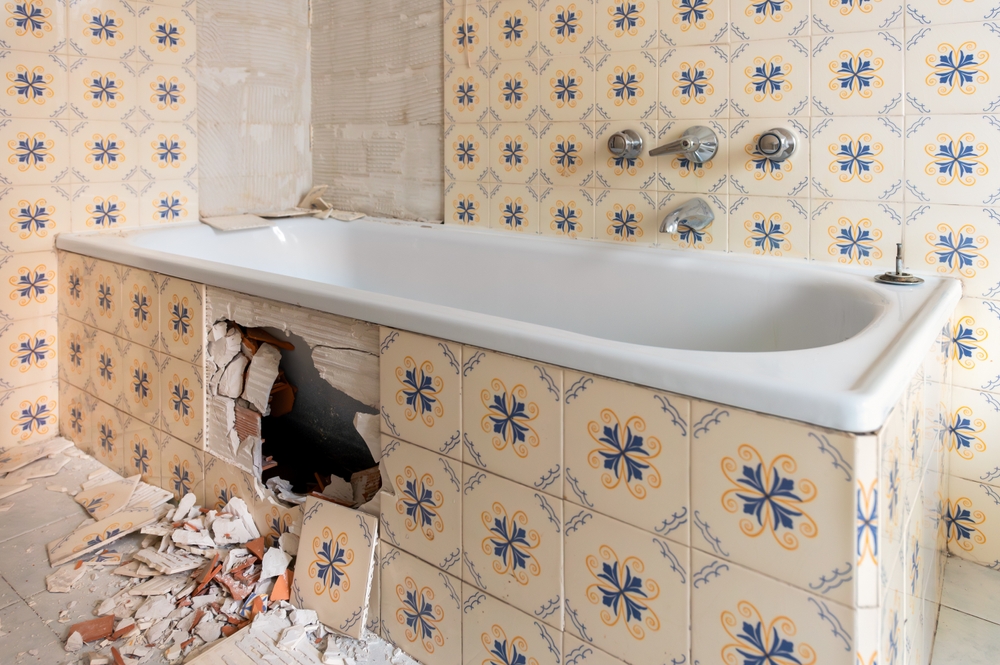 Removing old tiles and bathtub during bathroom renovation