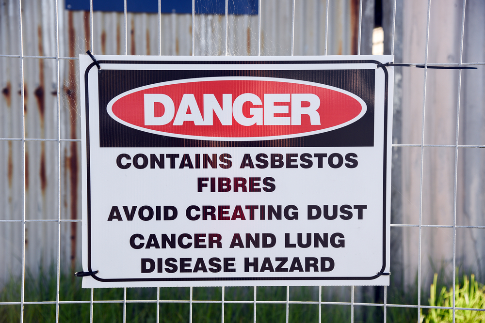 A warning sign at site being rehabilitated post asbestos contamination