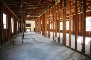 Interior demolition project in a commercial building showing exposed framing and stripped walls