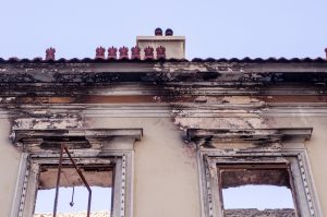 Burned building facade with fire-damaged walls and missing windows